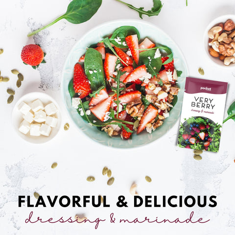 Very Berry salad dressing single serve packet next to strawberry salad with feta.
